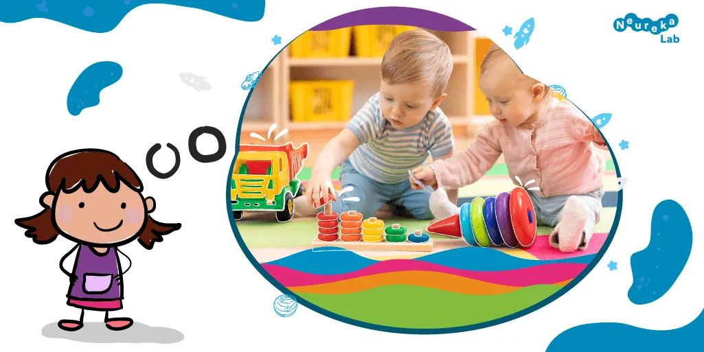 Nena pensant en dos infants petits que juguen amb joguines de colors per apilar i comptar